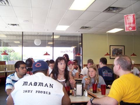 1995 Ford Probe - A group of people are gathered inside a casual dining establishment, enjoying food and conversation.