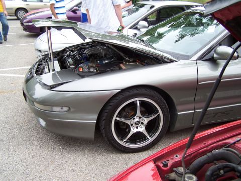1995 Ford Probe - A silver 1995 Ford Probe is displayed with its hood open, revealing the engine compartment.