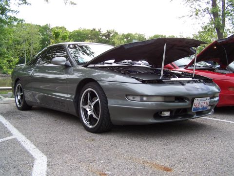 1995 Ford Probe - Gray 1995 Ford Probe parked outdoors with its hood open, next to another vehicle.