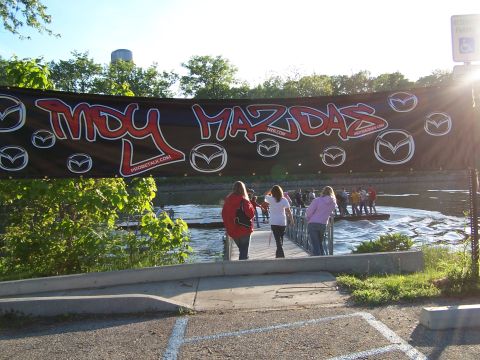 1995 Ford Probe - A banner hangs over a bridge, advertising an event for Mazda enthusiasts.