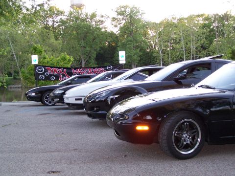 1995 Ford Probe - A line of Mazda vehicles, including a Miata in the foreground, are parked together.