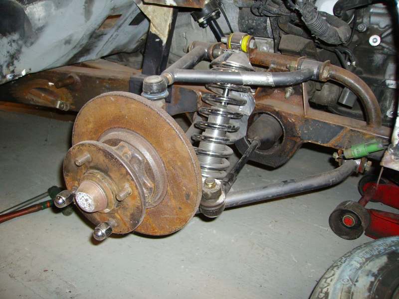 Truck front suspension with coil spring, hub, rotor and control arm