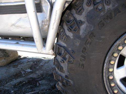 1994 Ford Bronco - Detail of an off-road tire and roll cage, suggesting off-road modification.