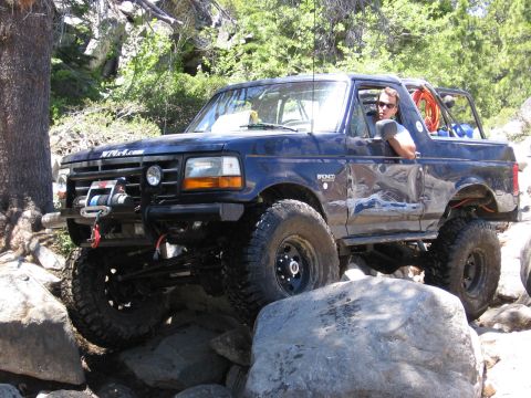 1994 Ford Bronco - This 1994 Ford Bronco is navigating a rocky off-road trail with a driver behind the wheel.