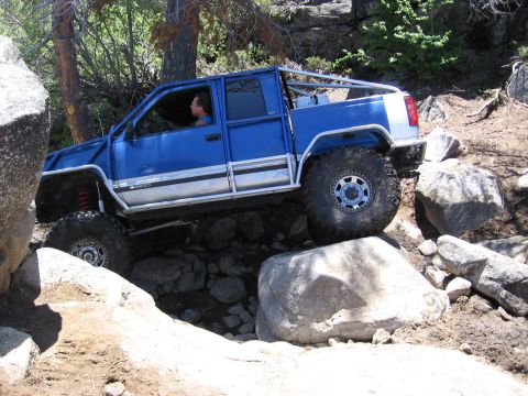 1994 Ford Bronco - This modified off-road vehicle navigates a challenging rocky terrain.
