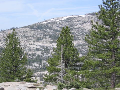 1994 Ford Bronco - A scenic view of a mountain range covered in rocks and trees, with a hint of snow on the peak.