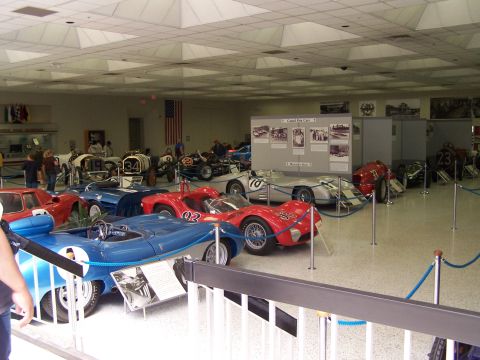 1995 Ford Probe - A museum exhibit showcases several vintage race cars, including a prominent blue open-wheel vehicle with racing numbers.
