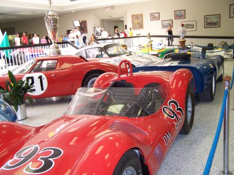 1995 Ford Probe - Multiple vintage race cars are on display in what appears to be a museum or exhibition hall.