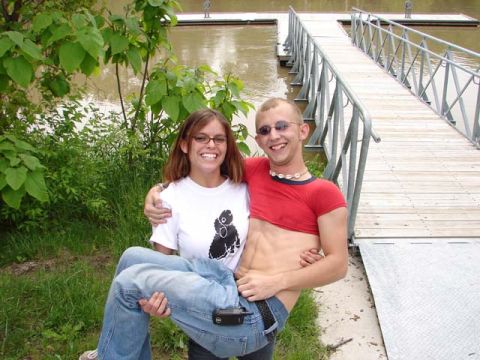 1995 Ford Probe - A couple poses for a photo on a wooden dock near a body of water.