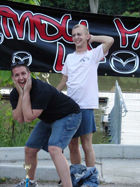 1995 Ford Probe - Two men are posing for a photo with a trophy in front of a banner.