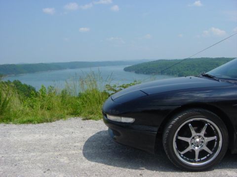 1995 Ford Probe - 1995 Ford Probe parked at a scenic overlook by a large lake.