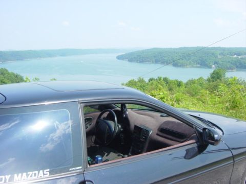 1995 Ford Probe - The interior of a Mazda MX-6 is shown with a scenic lake view behind it.