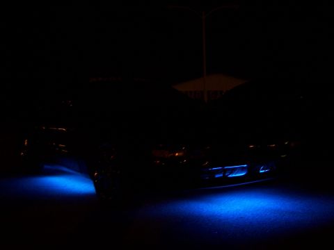 1995 Ford Probe - Car with blue underglow lights visible at night, front view. Text from website is present.