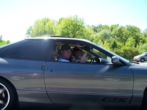 1995 Ford Probe - A gray 1995 Ford Probe is seen from the side with two occupants, one talking on the phone.