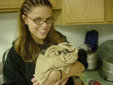 1995 Ford Probe - A woman smiles while holding a small kitten wrapped in a tan towel.