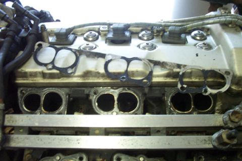1995 Ford Taurus - Close-up view of engine intake ports and detached manifold gaskets.