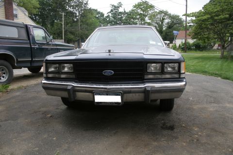 1989 Ford Crown Victoria LTD - Front view of a Ford Crown Victoria parked next to a pickup truck.