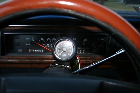 1989 Ford Crown Victoria LTD - Close-up of a car's dashboard, showing the speedometer, odometer, and an added tachometer.