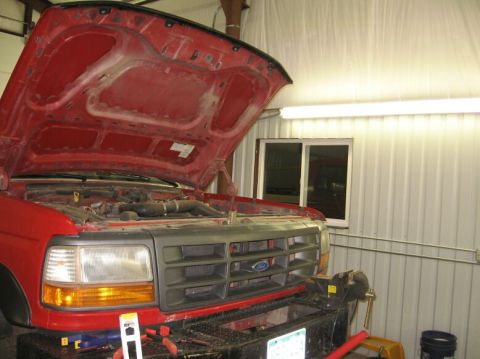 1986 Ford Ranger - Front view of a red truck with its hood open, revealing the engine compartment. The grille design suggests a 1992 model year.