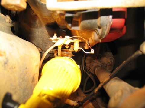 1978 Ford Bronco - Detail of an engine component, possibly related to transmission removal, with a prominent yellow part.