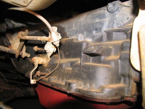 1978 Ford Bronco - The image shows a close-up view of a vehicle's transmission linkage, with a Ford logo visible on the casing.