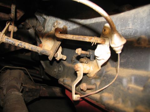 1978 Ford Bronco - Close-up view of a vehicle's transmission linkage, showing signs of wear and rust.