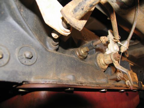 1978 Ford Bronco - Detail of a vehicle's transmission linkage, showing mechanical components and cables.