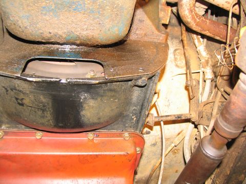1978 Ford Bronco - Underside view of a vehicle's transmission bell housing and oil pan, showing mechanical components.
