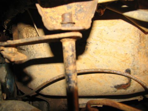 1978 Ford Bronco - Rusted metal bracket and linkage assembly, likely part of a vehicle's transmission system.