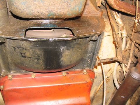 1978 Ford Bronco - Close-up view of the underside of a vehicle, focusing on the transmission and oil pan components.