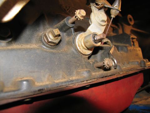 1978 Ford Bronco - Close-up view of a dusty transmission linkage assembly, showing various bolts and levers.