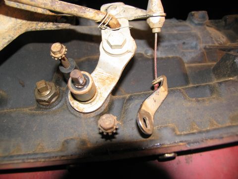 1978 Ford Bronco - A close-up view of a vehicle's transmission linkage, showing mechanical components and a cable.