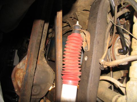 1978 Ford Bronco - Close-up view of the undercarriage of a 1978 Ford Bronco, highlighting the rear axle and a red shock absorber.