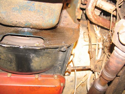1978 Ford Bronco - Close-up of vehicle undercarriage components, including transmission and exhaust system parts.