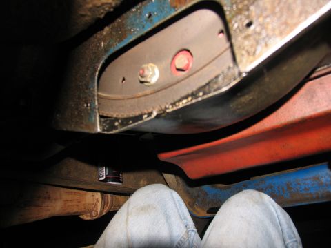 1978 Ford Bronco - Underside view of a vehicle's frame and exhaust system, with a can visible on a crossmember.