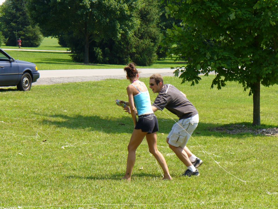 Dark blue sedan parked on grass, side view