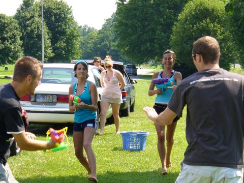 1991 Ford Probe - A white sedan is parked in the background during an outdoor water gun fight.