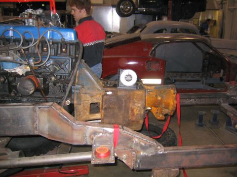 1982 Ford Bronco - Workshop scene with an engine and chassis assembly, possibly for a vehicle restoration or build.