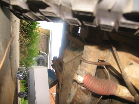1978 Ford Bronco - Close-up of a vehicle's undercarriage, focusing on suspension parts and rusty metal.