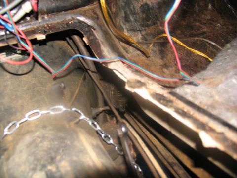 1978 Ford Bronco - A close-up view of the interior of a vehicle, revealing exposed wiring and mechanical components.