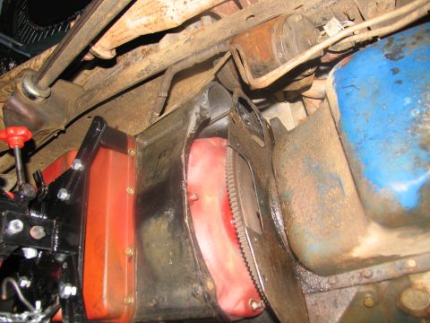 1978 Ford Bronco - Close-up view of the engine and transmission assembly from underneath a vehicle.