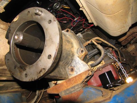 1978 Ford Bronco - Underside view of a vehicle's transmission assembly, showing the driveshaft and surrounding components during a repair.