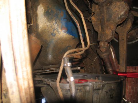 1978 Ford Bronco - Close-up view of a vehicle's undercarriage, focusing on the transmission and associated components.