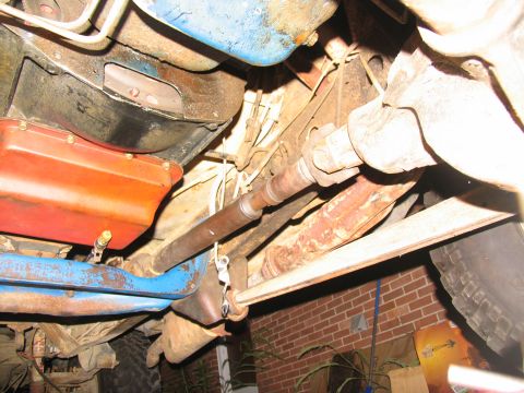 1978 Ford Bronco - Close-up view of the drivetrain components, including the transmission and driveshaft, of an unidentified vehicle.