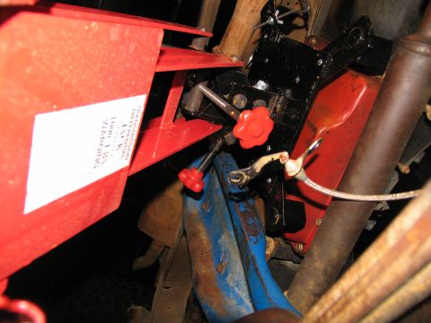 1978 Ford Bronco - A transmission jack is positioned beneath the vehicle's frame, ready for component removal.