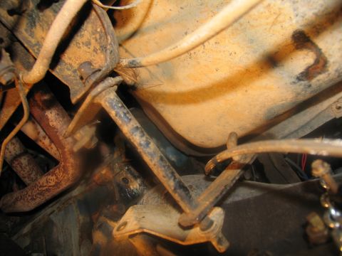 1978 Ford Bronco - Close-up of vehicle undercarriage, showing exhaust manifold and linkage.