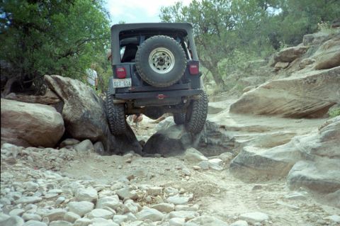 1982 Ford Customline - A Jeep Wrangler navigates a challenging rocky trail, demonstrating its off-road capabilities.