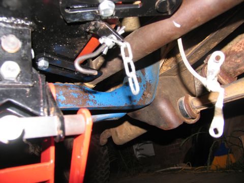 1978 Ford Bronco - Close-up view of vehicle undercarriage components, including frame, exhaust, and suspension parts.