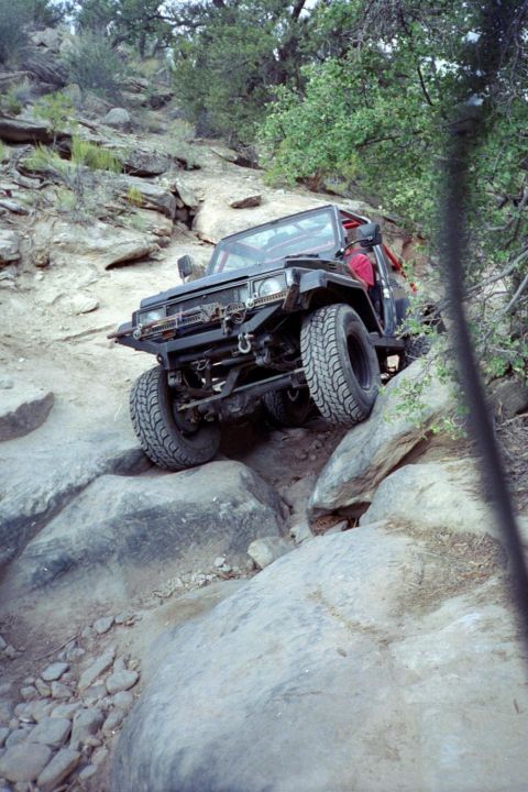 1982 Ford Customline - This off-road vehicle tackles a challenging rocky path, demonstrating its capability on difficult terrain.