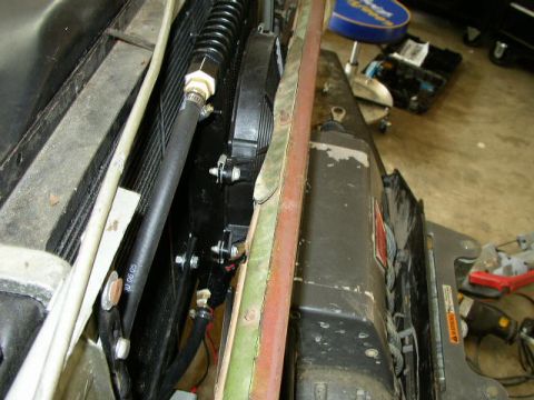 1995 Ford Bronco - Close-up view of the engine bay, focusing on the radiator and cooling fan assembly with visible hoses and wiring.